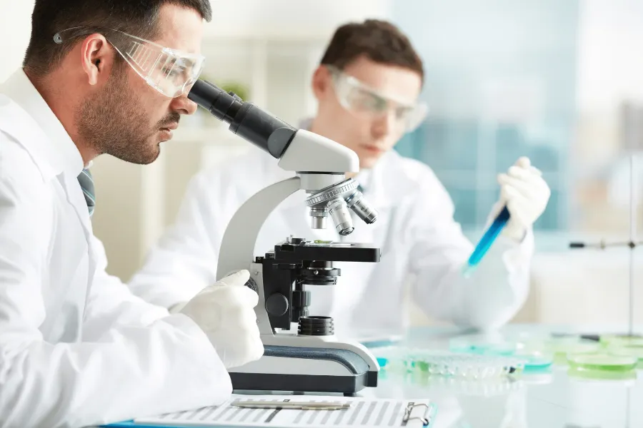 Laboratory technicians at a microscope